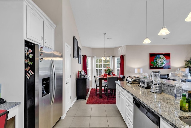 kitchen with stainless steel appliances, light stone countertops, pendant lighting, light tile patterned floors, and white cabinets