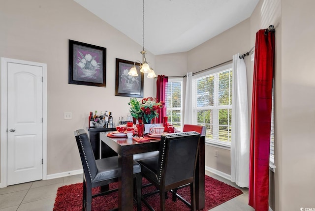 dining space featuring lofted ceiling, an inviting chandelier, and light tile patterned floors