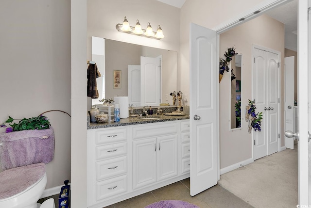 bathroom featuring vanity, toilet, and tile patterned floors