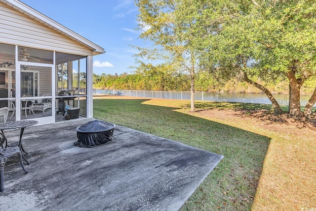 view of yard featuring a patio, ceiling fan, and a sunroom