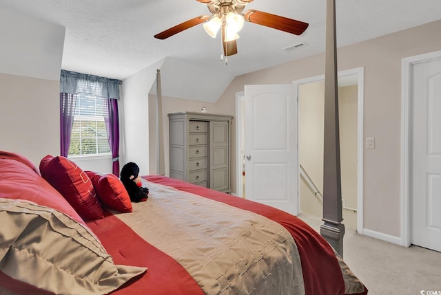 carpeted bedroom featuring ceiling fan, a textured ceiling, and vaulted ceiling