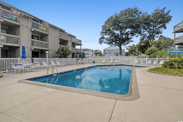 view of swimming pool featuring a patio area