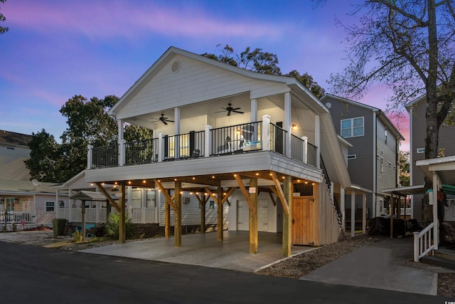 view of front of house featuring ceiling fan and a carport