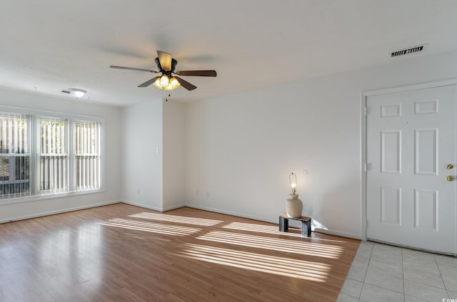 spare room featuring ceiling fan and light hardwood / wood-style floors