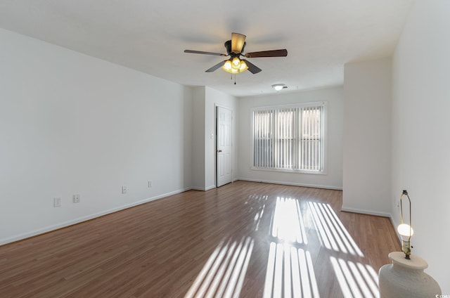 empty room featuring hardwood / wood-style flooring and ceiling fan