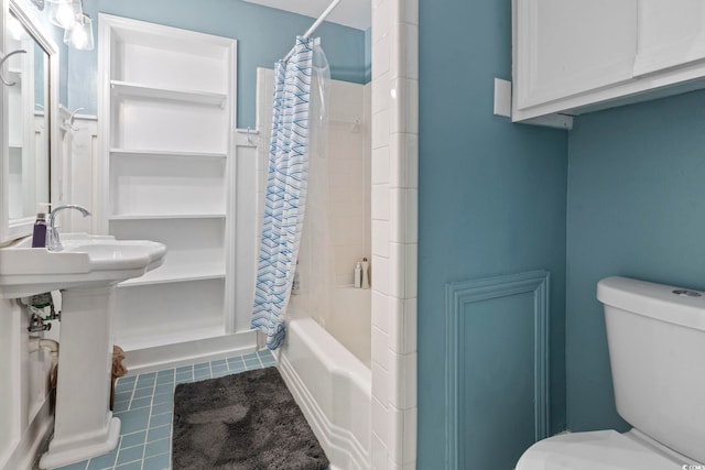 bathroom featuring shower / bath combination with curtain, toilet, and tile patterned floors