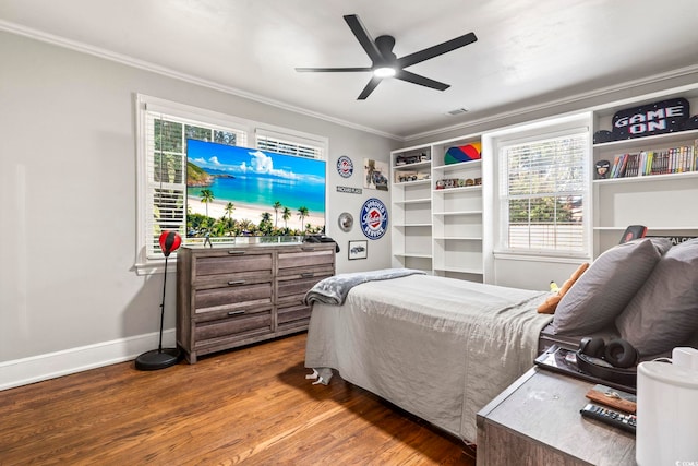 bedroom featuring ornamental molding, wood-type flooring, and ceiling fan