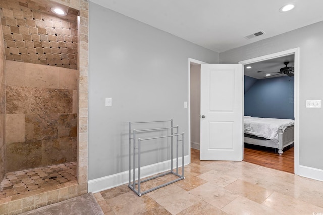 bathroom featuring ceiling fan and tiled shower