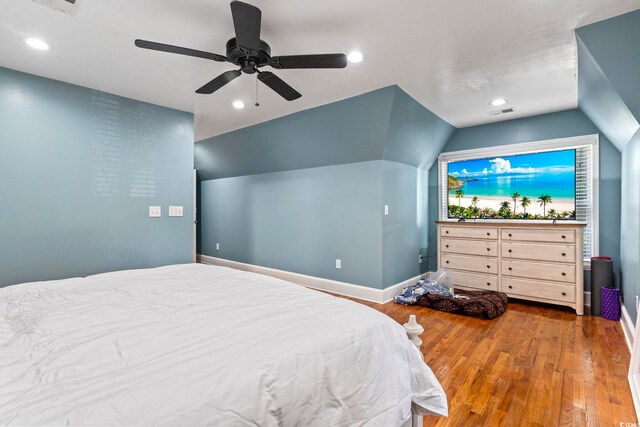 bedroom with ceiling fan, wood-type flooring, and lofted ceiling