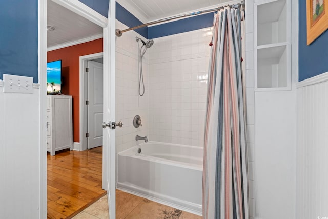 bathroom with crown molding, hardwood / wood-style floors, and shower / bath combination with curtain