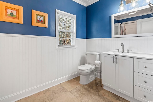 bathroom with vanity, crown molding, tile patterned flooring, and toilet