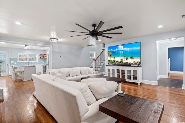 living room with ceiling fan and hardwood / wood-style flooring