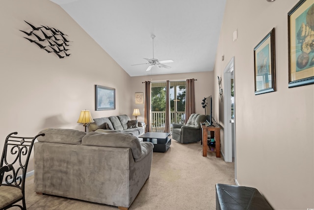 carpeted living room with ceiling fan and high vaulted ceiling