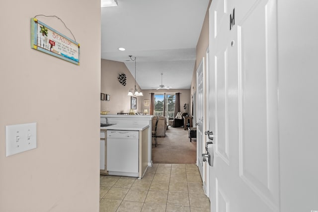 kitchen with lofted ceiling, light carpet, white dishwasher, decorative light fixtures, and ceiling fan