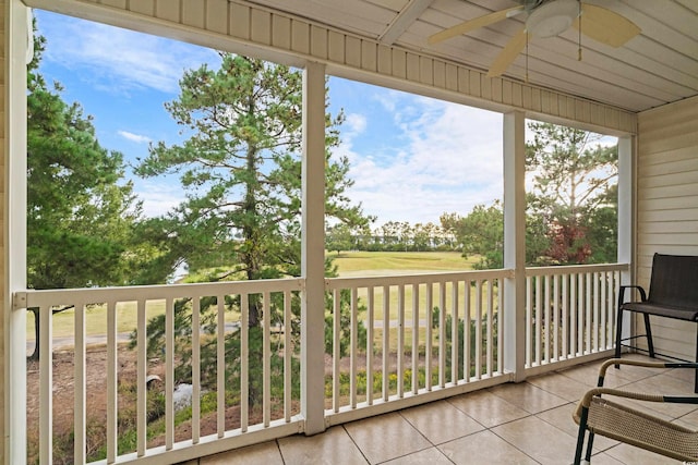 sunroom with ceiling fan and wood ceiling