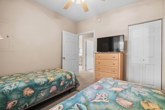 carpeted bedroom with a closet, electric panel, and ceiling fan