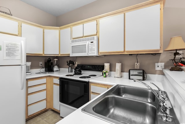 kitchen with white cabinets, white appliances, and light tile patterned flooring