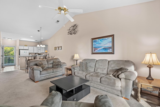 carpeted living room with high vaulted ceiling and ceiling fan