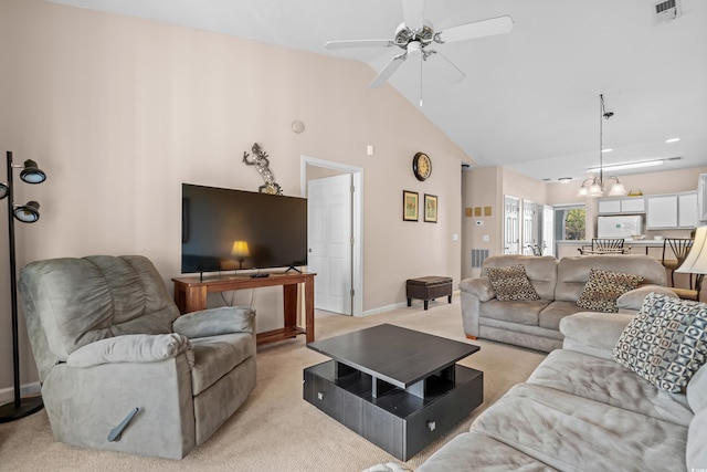 living room with ceiling fan with notable chandelier, high vaulted ceiling, and light colored carpet