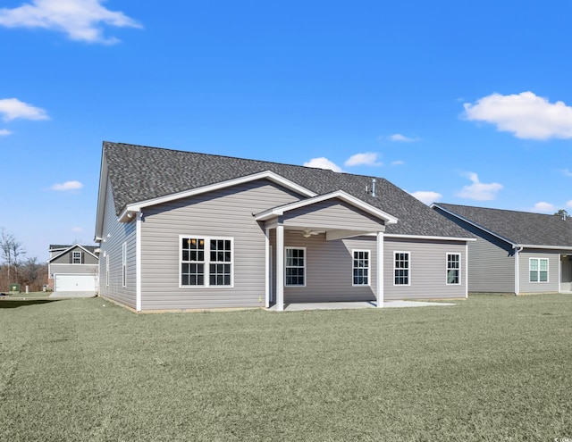 rear view of property featuring a lawn and a patio