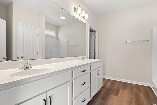 bathroom with a shower, wood-type flooring, and vanity