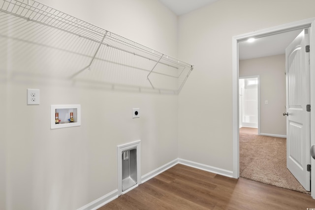 washroom with electric dryer hookup, hookup for a washing machine, and hardwood / wood-style floors