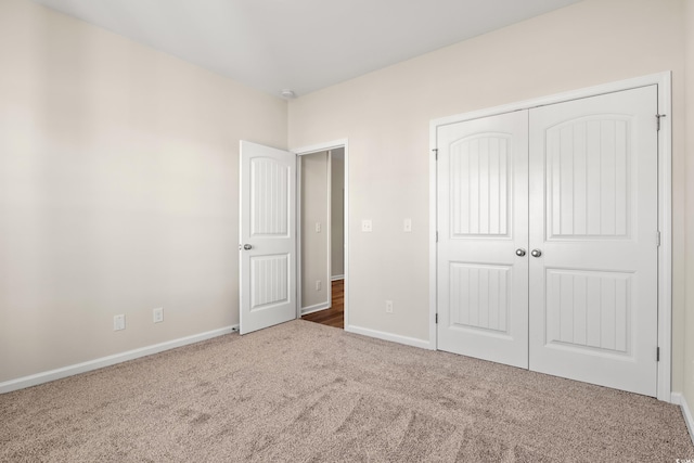 unfurnished bedroom featuring a closet and carpet flooring