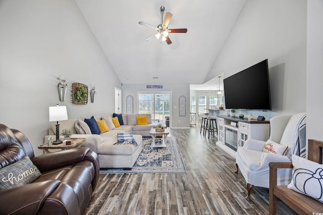 living room featuring high vaulted ceiling, hardwood / wood-style flooring, and ceiling fan