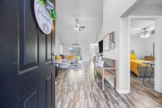 entryway featuring hardwood / wood-style flooring, ceiling fan, and vaulted ceiling