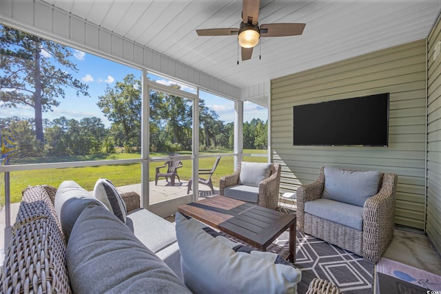 sunroom / solarium featuring ceiling fan