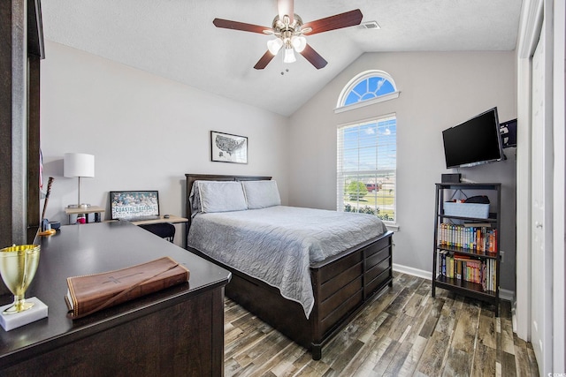 bedroom with lofted ceiling, ceiling fan, a textured ceiling, and dark hardwood / wood-style flooring