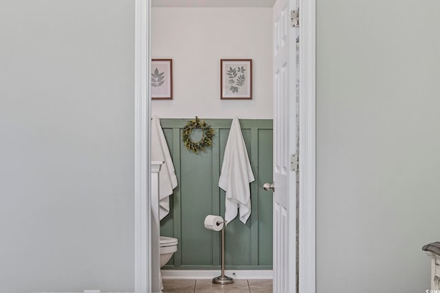 bathroom with toilet and tile patterned flooring