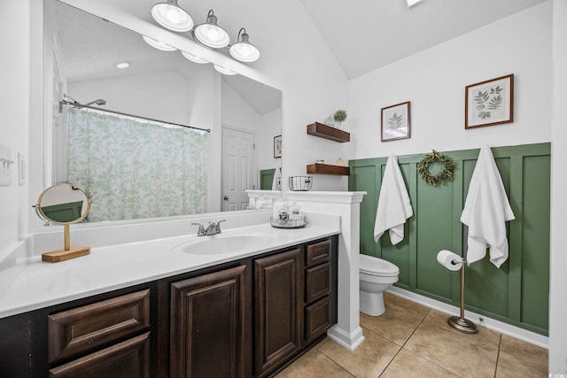 bathroom featuring vanity, toilet, tile patterned floors, and vaulted ceiling