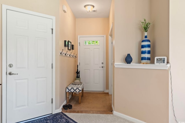 doorway featuring carpet flooring