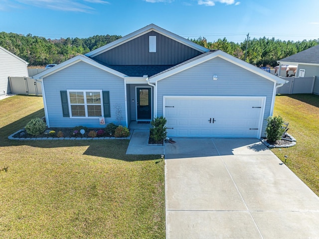 ranch-style house with roof with shingles, concrete driveway, an attached garage, fence, and a front lawn