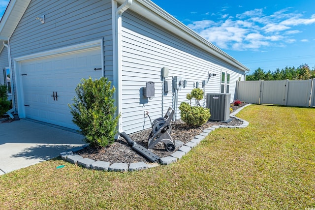 view of home's exterior with central AC unit, a garage, and a lawn