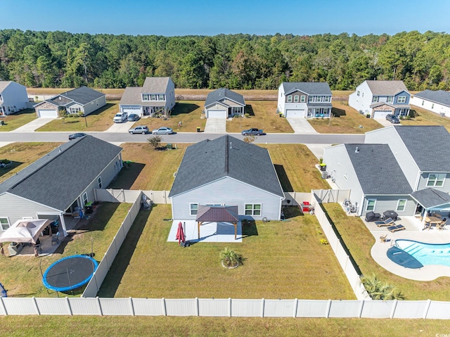 birds eye view of property with a residential view and a wooded view