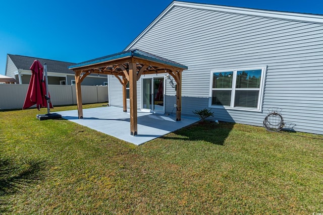 rear view of house with a patio area, fence, a lawn, and a gazebo