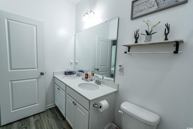 bathroom with vanity, hardwood / wood-style flooring, and toilet