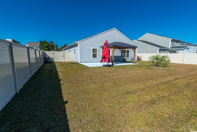 back of property featuring a yard, a patio, a gazebo, a gate, and a fenced backyard