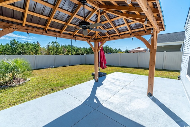 view of patio featuring a gazebo, a fenced backyard, and a ceiling fan