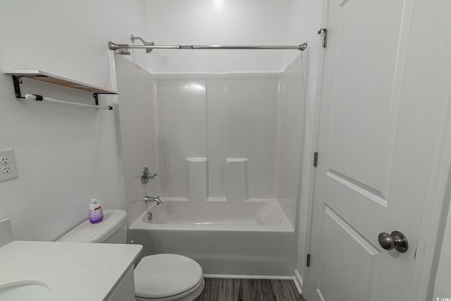 bathroom with tub / shower combination, vanity, toilet, and wood finished floors