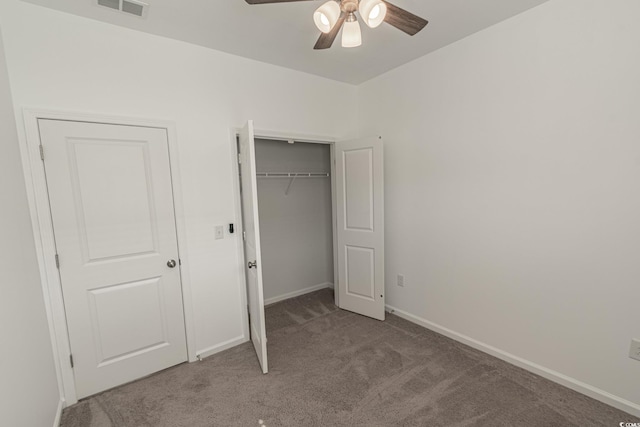 unfurnished bedroom with carpet flooring, a ceiling fan, visible vents, baseboards, and a closet