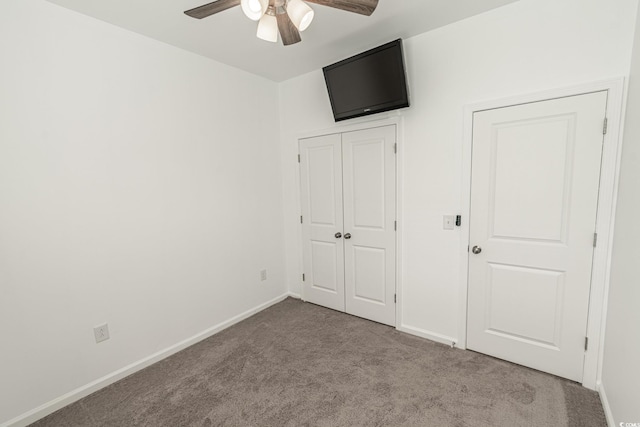 unfurnished bedroom with light carpet, baseboards, and a ceiling fan