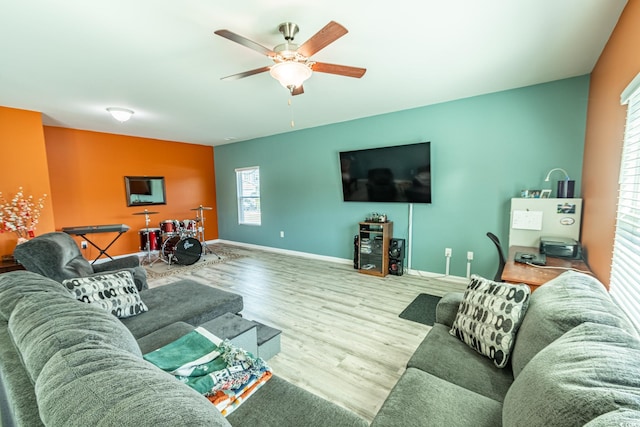 living room featuring hardwood / wood-style floors and ceiling fan