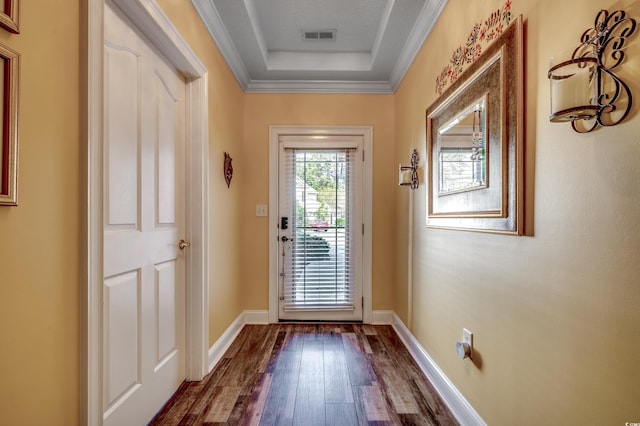 doorway featuring ornamental molding, hardwood / wood-style flooring, and a textured ceiling