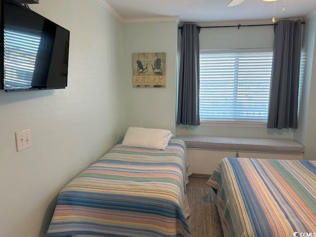 bedroom with ornamental molding and ceiling fan