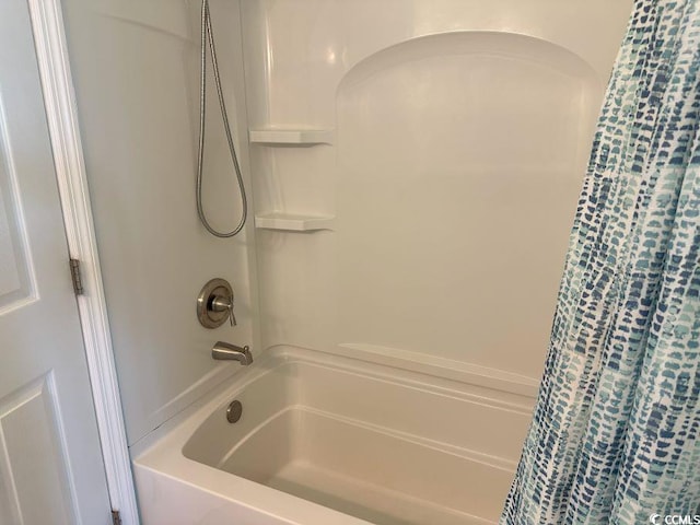 bathroom with shower / bath combo with shower curtain