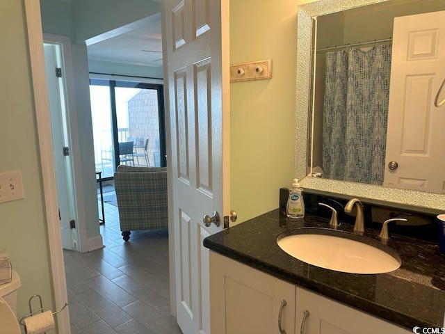 bathroom featuring toilet, vanity, and tile patterned floors