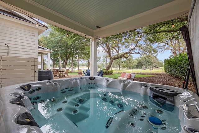 view of swimming pool with a hot tub